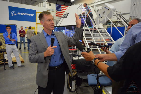 Chris Ferguson, who commanded the final mission of the space shuttle two years ago, talks with media gathered to tour Boeing's CST-100 commercial spacecraft model, July 22, 2013.