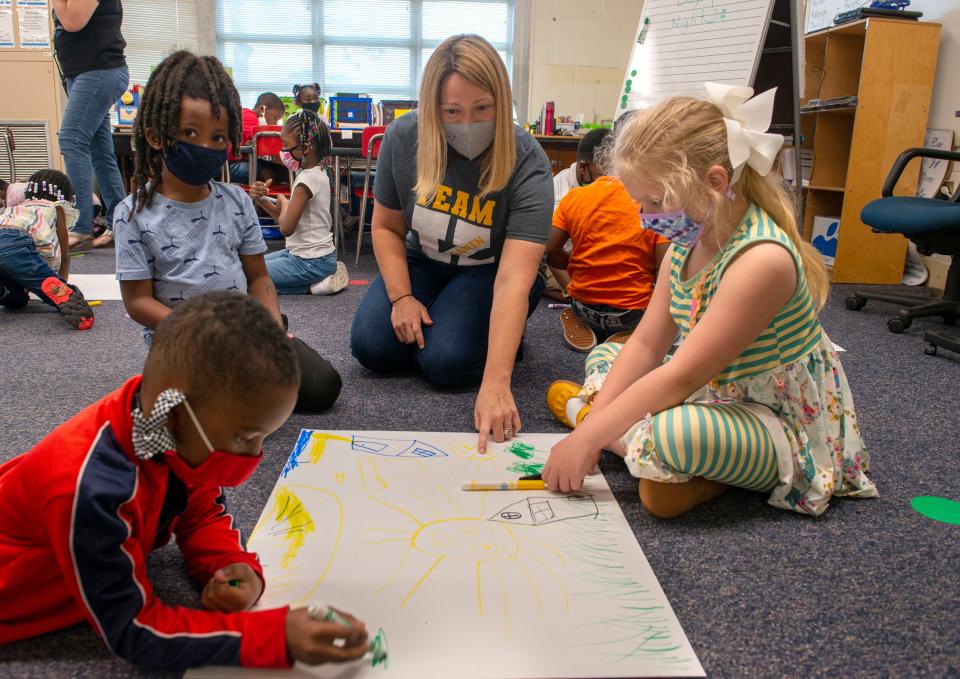 Kindergarten teacher Amber Cotita helps her students in her classroom at O. J. Semmes Elementary School in this April 30, 2021, file photo.