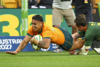 Australia's Len Ikitau, left, scores a try as South Africa's Franco Mostert attempts a tackle during the Rugby Championship test match between the Springboks and the Wallabies in Brisbane, Australia, Saturday, Sept. 18, 2021. (AP Photo/Tertius Pickard)