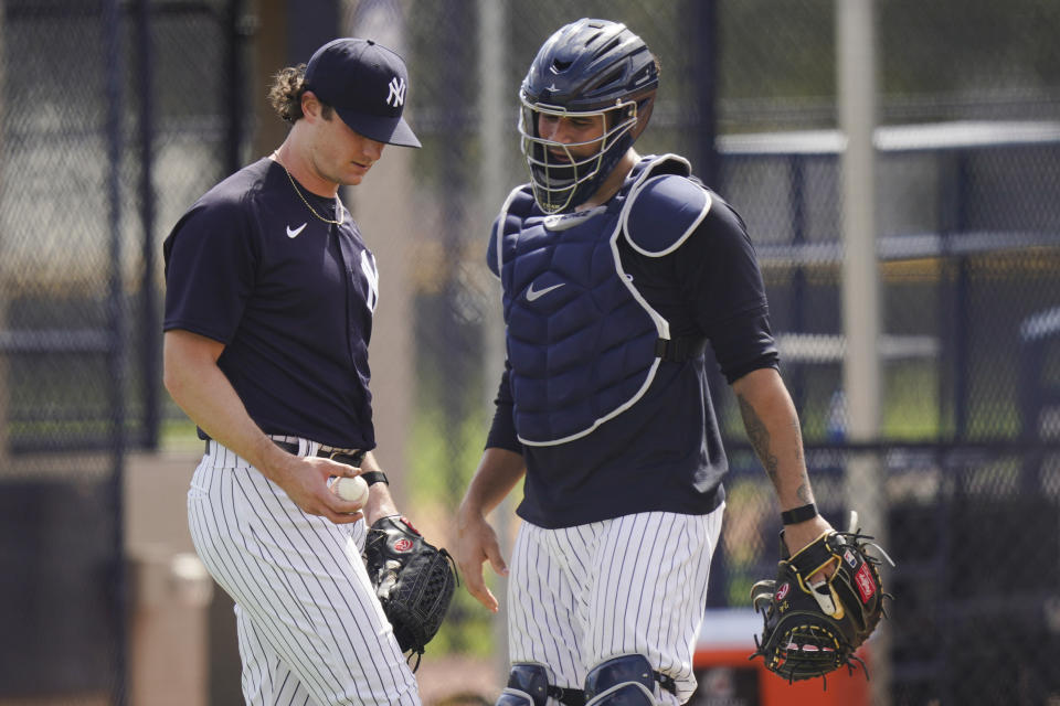 New York Yankees' Gerrit Cole, left, talks to catcher Gary Sanchez after a spring training baseball workout Monday, Feb. 22, 2021, in Tampa, Fla. (AP Photo/Frank Franklin II)