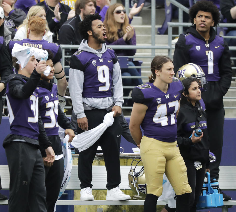 Injured Washington running back Myles Gaskin (9) stands on the bench in sweats during the first half of an NCAA college football game against Colorado, Saturday, Oct. 20, 2018, in Seattle. Gaskin did not play in the game. (AP Photo/Ted S. Warren)