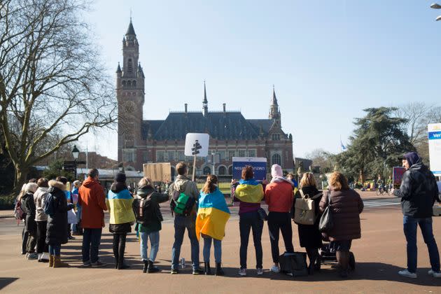 Ukrainian nationals stand outside the International Criminal Court of Justice, or Peace Palace, on the first day of hearings on March 7 in The Hague. (Photo: Michel Porro via Getty Images)