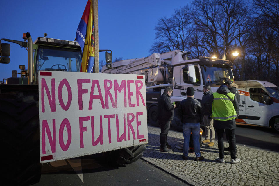 "No Farmer, no Future" is written on a sign attached to one of the tractors at a farmers' protest on Stra'e des 17. Juni in front of the Brandenburg Gate in Berlin, Germany, Monday, Jan. 8, 2024. Farmers blocked highway access roads in parts of Germany Monday and gathered for demonstrations, launching a week of protests against a government plan to scrap tax breaks on diesel used in agriculture. (J'rg Carstensen/dpa via AP)