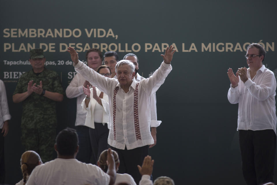 Mexican President Andres Manuel Lopez Obrador gestures during an event with El Salvadorian President Nayib Bukele, not in picture, at a military nature reserve near the border town of Tapachula, Mexico, Thursday, June 20, 2019. At right is Mexican Foreign Minister Marcelo Ebrard. Lopez Obrador met with El Salvador's president to discuss a development plan that aims to slow a surge of mostly Central American migrants toward the U.S. border. (AP Photo/Oliver de Ros)