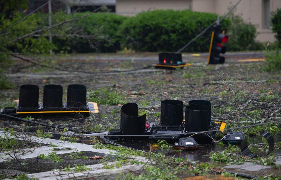 Traffic lights, utility lines and debris cover the street at the intersection of Longleaf and Community Drives as a storm passes through the Pensacola area on Wednesday, April 10, 2024.