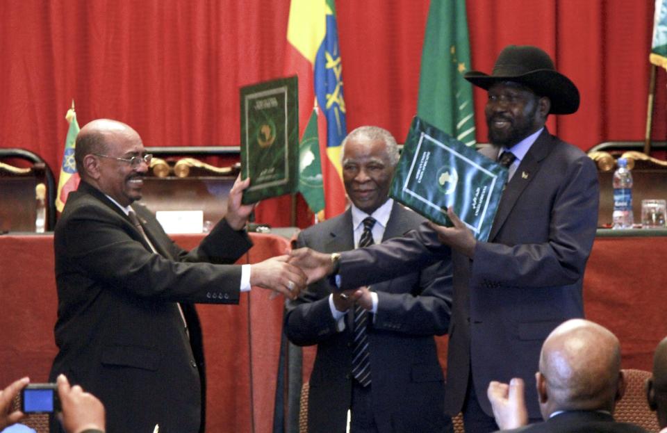 Sudan's President Omar al-Bashir, left, and South Sudan President Salva Kiir, right, shake hands on the completion of a signing ceremony after the two countries reached a deal on economic and security agreements Thursday, Sept. 27, 2012 in Addis Ababa, Ethiopia. The presidents of Sudan and South Sudan signed agreements Thursday that will allow a resumption of oil exports from South Sudan, a demilitarized zone between their borders, and a cessation of all hostilities that brought the countries to the brink of all-out war just a few months ago. (AP Photo/Elias Asmare)