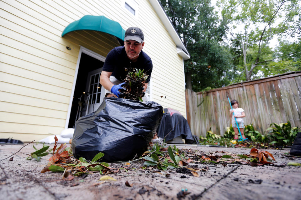 <p>John Codella clears debris caused by Hurricane Nate from his yard, in Biloxi, Mississippi, U.S., October 8, 2017. (Photo: Jonathan Bachman/Reuters) </p>