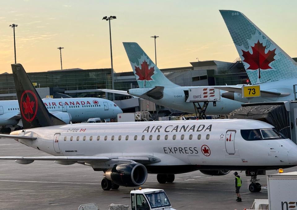 Air Canada planes are seen at the gates at Montreal International Airport (AFP via Getty)