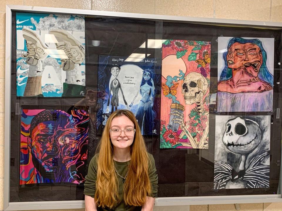 Jessie Waddell stands near some of her art that is on display at Port Clinton High School.