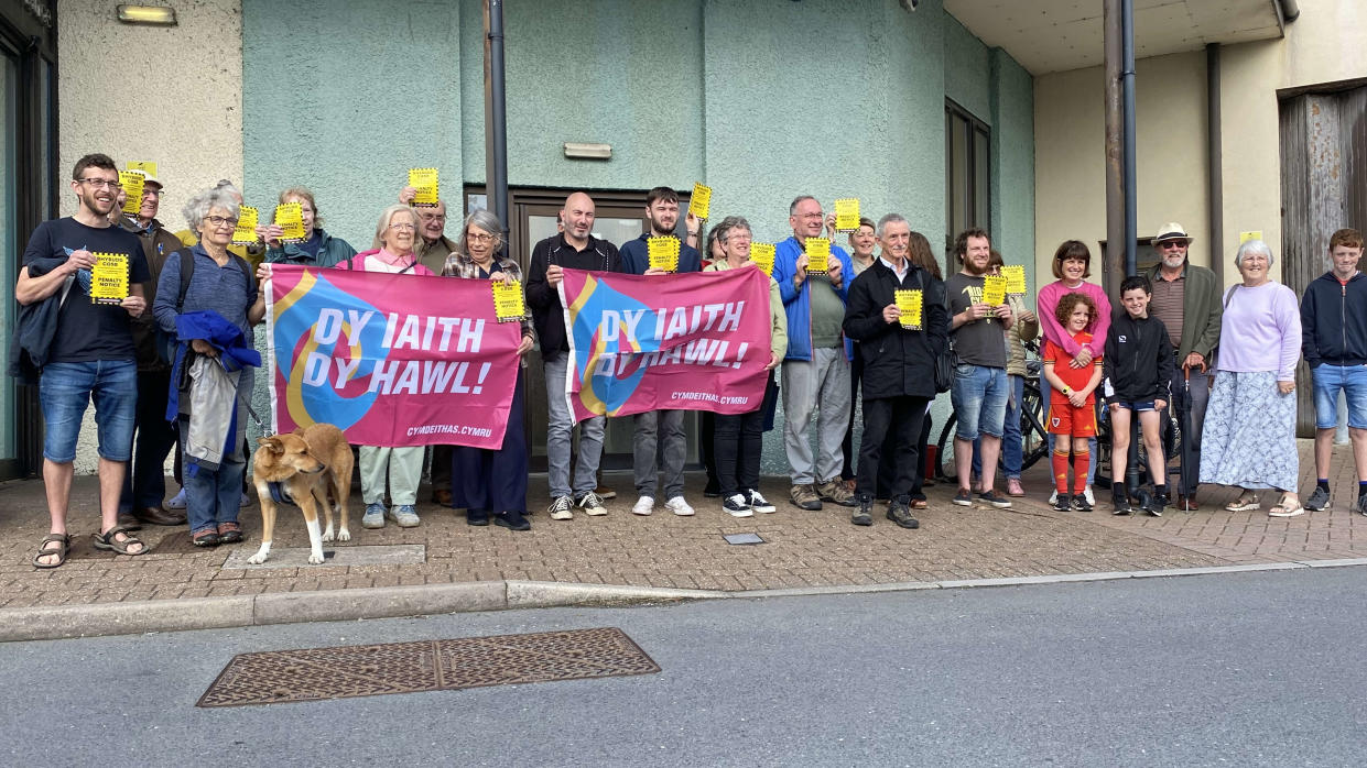 Campaigners outside Aberystwyth Justice Centre in August 2023. Release date April 29 2024. A retired teacher who refused to pay an English-only parking fine in Wales could face a £10,000 legal bill. Language campaigner Toni Schiavone will appear in court in Aberystwyth for the fourth time on May 13. It is over his refusal to pay an English-only parking charge notice - after the parking company One Parking Solution won an appeal to reintroduce the case in January. This is despite the judge, Gareth Humphreys, warning that the company should carefully consider the value of continuing with a case that has already been 