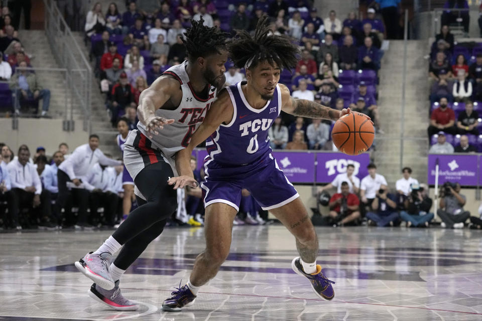 TCU guard Micah Peavy (0) works against Texas Tech 's Joe Toussaint (6) for a shot opportunity in the first half of an NCAA college basketball game in Fort Worth, Texas, Tuesday, Jan. 30, 2024. (AP Photo/Tony Gutierrez)
