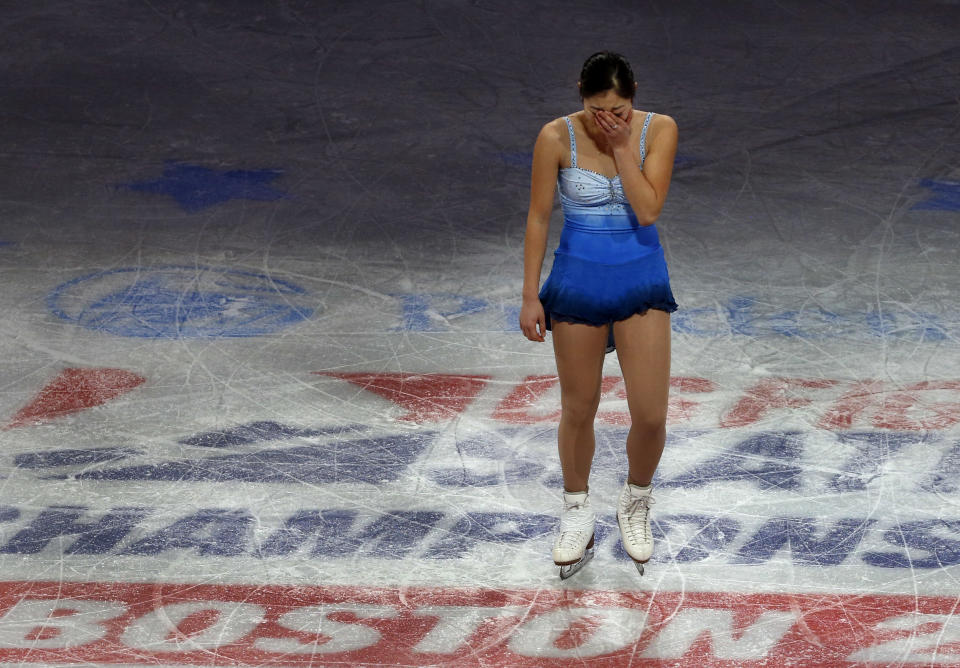 Mirai Nagasu becomes emotional at mid-ice prior to her performance during the skating spectacular after the U.S. Figure Skating Championships in Boston, Sunday, Jan. 12, 2014. Women's third finisher Nagasu, the only one of the top four finishers with Olympic experience, was bumped in favor of Ashley Wagner when U.S. Figure Skating announced the selections earlier Sunday. (AP Photo/Elise Amendola)