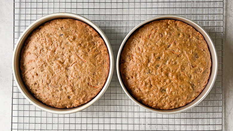 Vegan carrot cakes cooling on rack in round cake pans