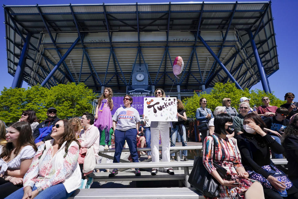 Pat Conn, center left, and Staci McKeown cheer on Tucker as he competes in the dock diving competition during the 147th Westminster Kennel Club Dog show, Saturday, May 6, 2023, at the USTA Billie Jean King National Tennis Center in New York. (AP Photo/Mary Altaffer)