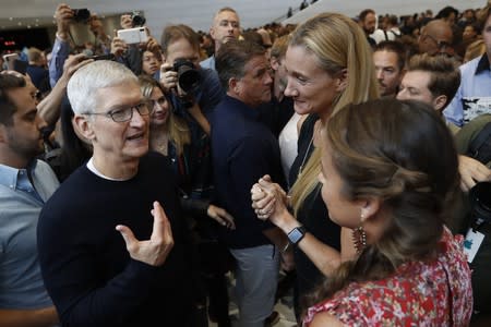 CEO Tim Cook speaks with people in the demonstration room at an Apple event at their headquarters in Cupertino