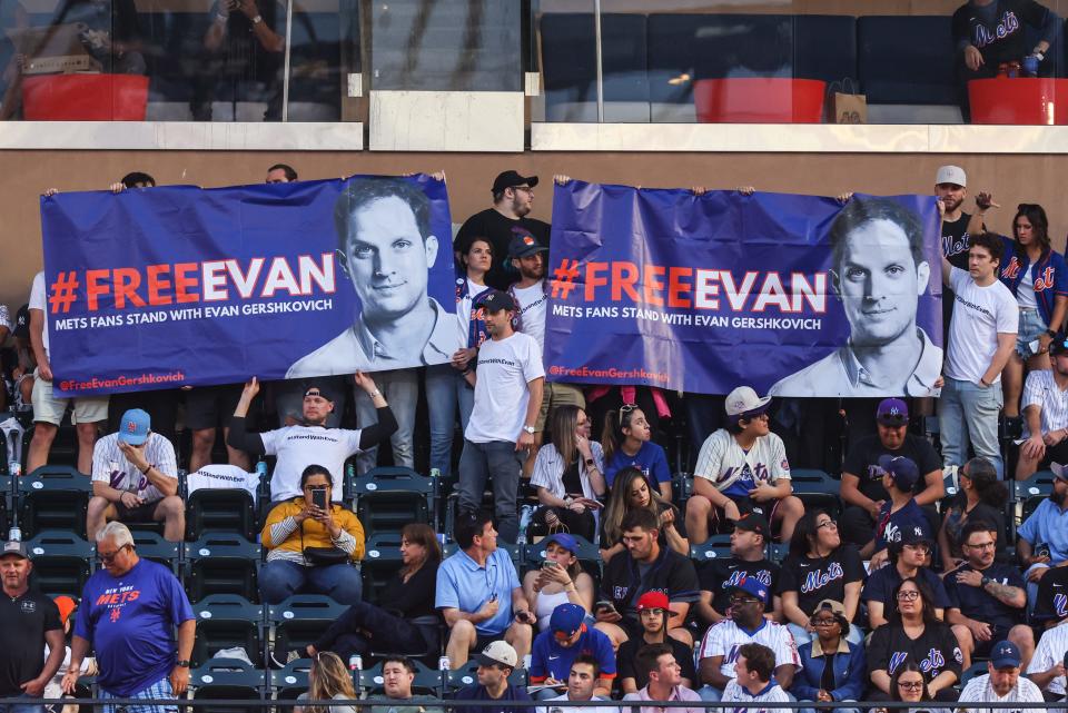 Jun 13, 2023; New York City, New York, USA; Fans display a banner in support of Wall Street Journal reporter Evan Gershkovich, who has been detained by authorities in Russia during the third inning of the MLB game between the New York Mets and the New York Yankees at Citi Field. Mandatory Credit: Vincent Carchietta-USA TODAY Sports