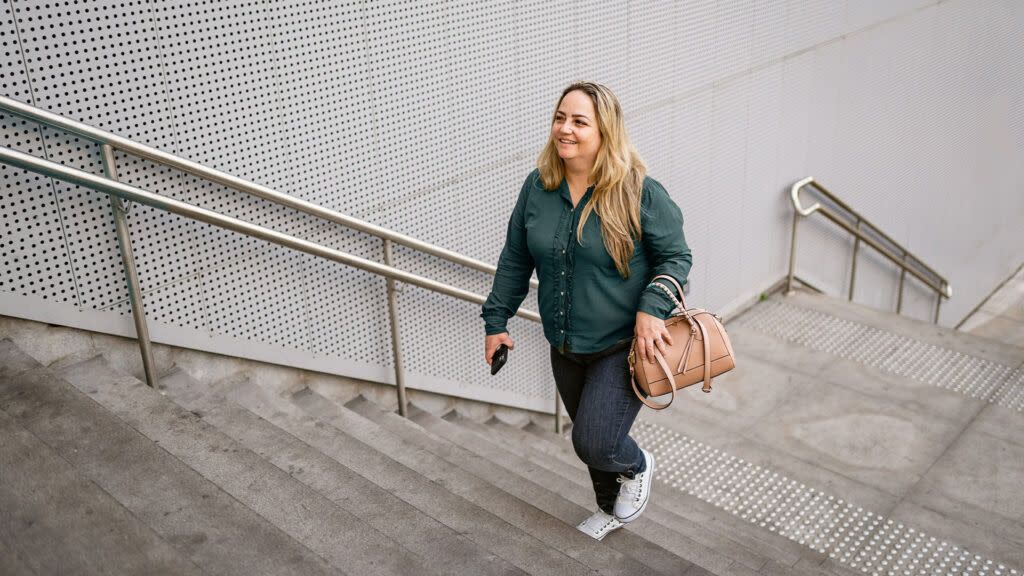 A woman walks up a flight of stairs