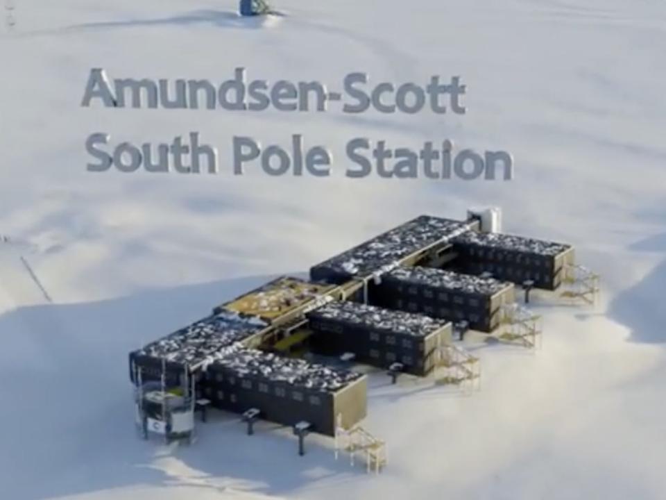 A 3D rendering of the Amundsen-Scott South Pole station's elevated building. It has four wings and is seen here set against a snowy background.