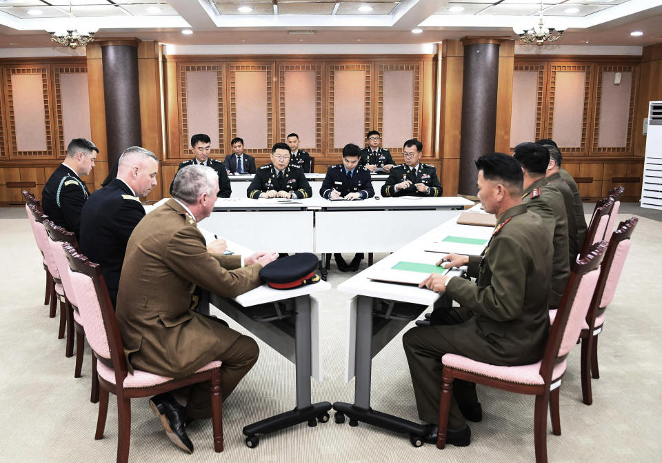 In this photo provided by South Korea Defense Ministry, the U.S.-led United Nations Command, left, South Korean and North Korean, right, military officers attend a meeting at the southern side of Panmunjom in the Demilitarized Zone, South Korea, Tuesday, Oct. 16, 2018. The rival Koreas and the U.S.-led United Nations Command were meeting Tuesday to discuss efforts to disarm a military zone the rivals control within their shared border under a peace agreement between the Koreas. (South Korea Defense Ministry via AP)