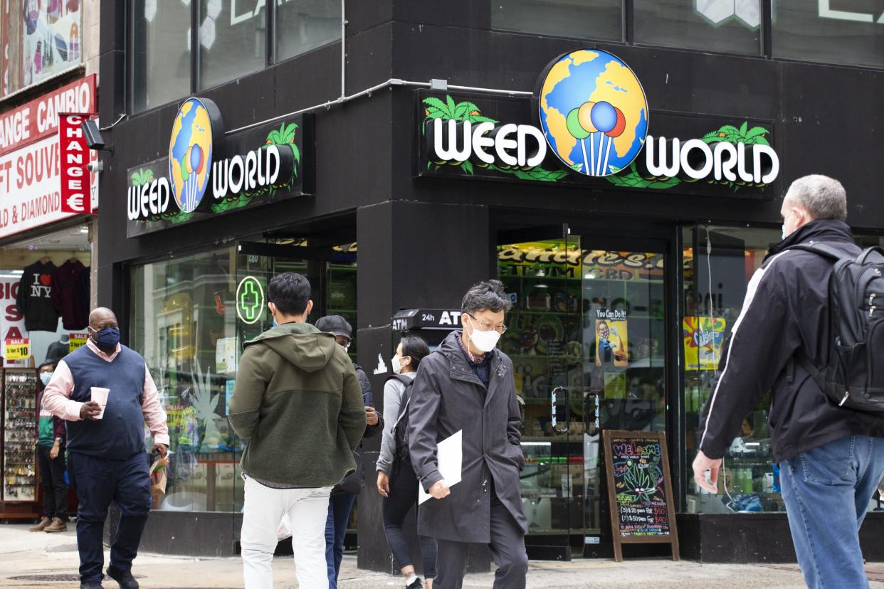 People walk past the Weed World store in Manhattan, New York on March 31, 2021.