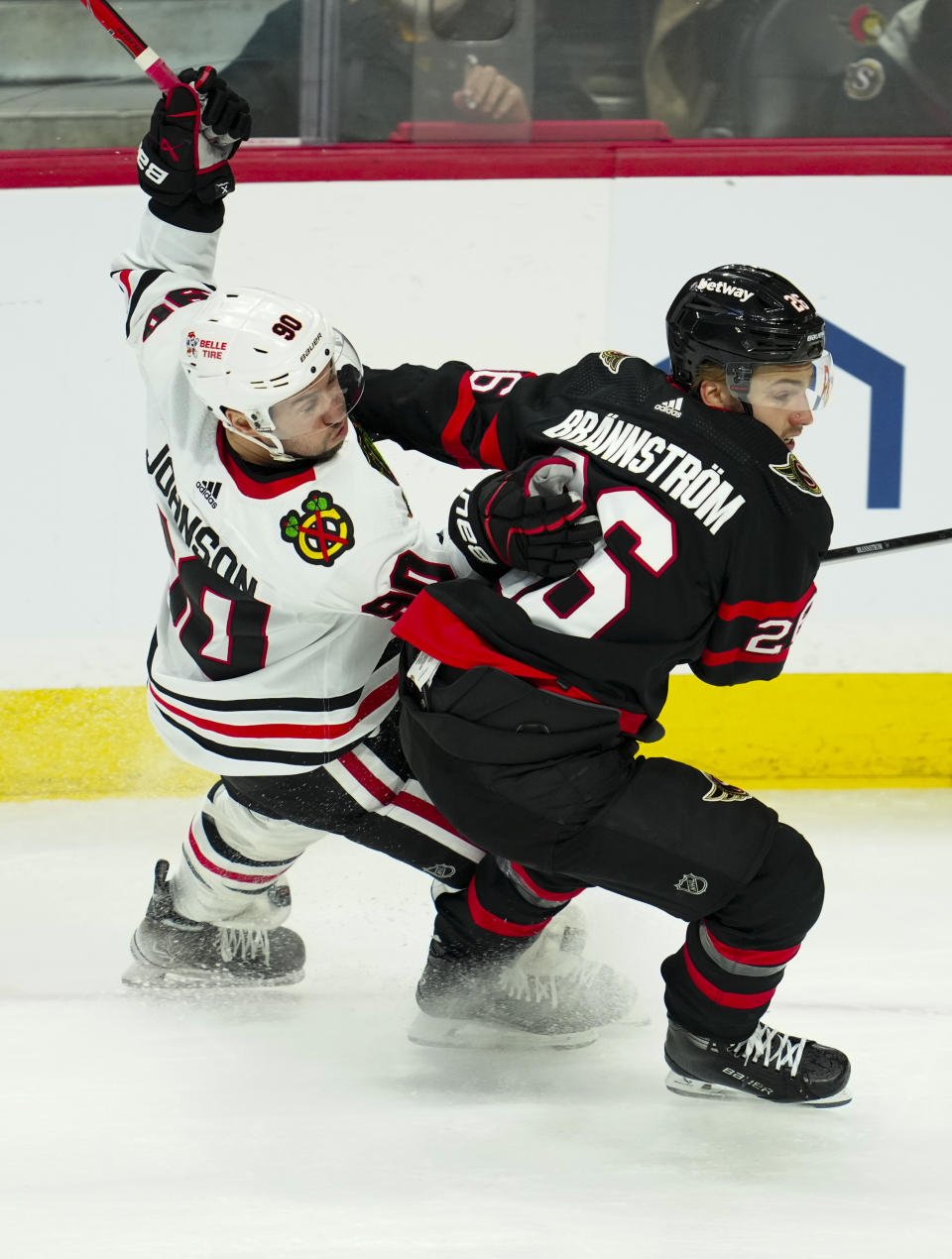 Ottawa Senators defenseman Erik Brannstrom gets tangled up with Chicago Blackhawks center Tyler Johnson during the second period of an NHL hockey game in Ottawa, Ontario, on Thursday, March 28, 2024. (Sean Kilpatrick/The Canadian Press via AP)