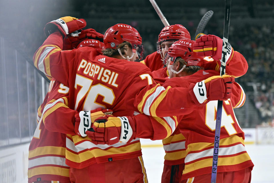 The Calgary Flames celebrate a goal by Nazem Kadri against the Vegas Golden Knights during the first period of an NHL hockey game Saturday, Jan. 13, 2024, in Las Vegas. (AP Photo/David Becker)