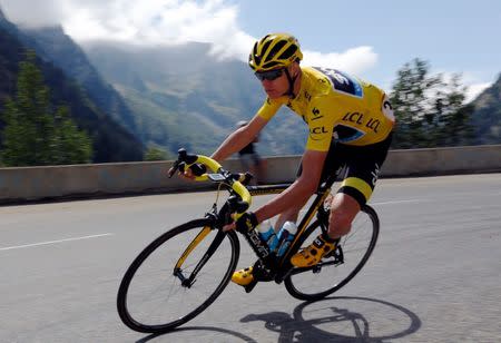 FILE PHOTO: Team Sky rider Chris Froome of Britain wears the race leader's yellow jersey as he speeds downhill during the 110.5-km (68.6 miles) 20th stage of the 102nd Tour de France cycling race from Modane to Alpe d'Huez in the French Alps mountains, France. REUTERS/Stefano Rellandini/File Photo