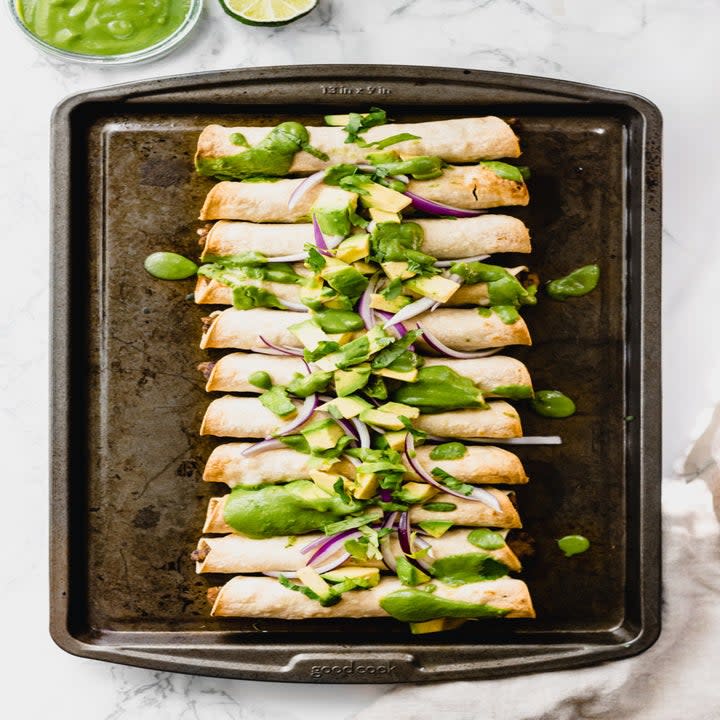 A row of small tortillas on an oblong plate