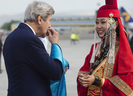 U.S. Secretary of State John Kerry samples cheese curds presented by a woman in traditional attire (R) upon his arrival at Chinggis Khaan International Airport in Ulaanbaatar, Mongolia, June 5, 2016. REUTERS/Saul Loeb/Pool