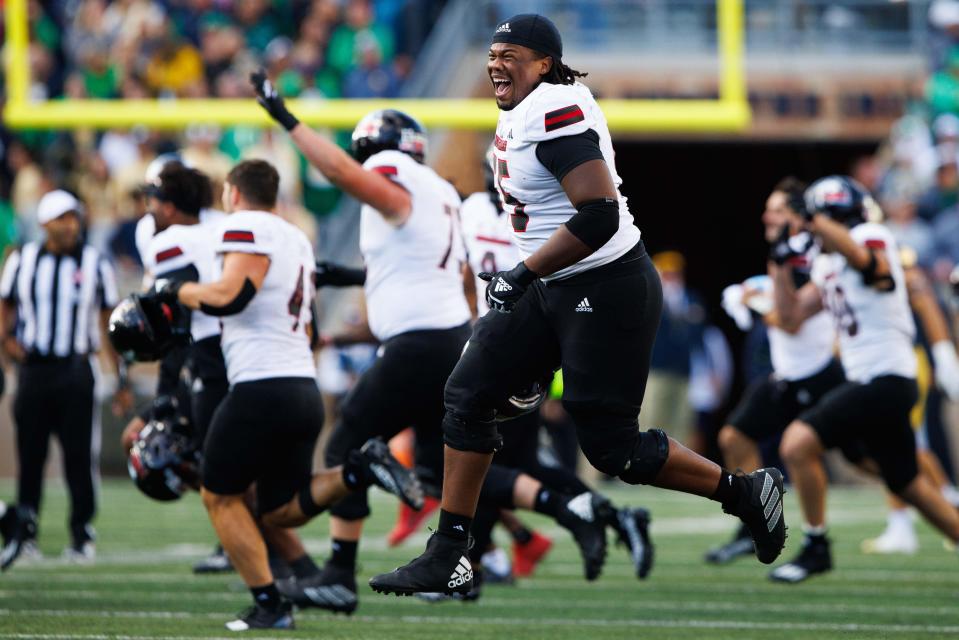 Northern Illinois offensive lineman Abiathar Curry jumps in the air in celebration after winning a NCAA college football game 16-14 against Notre Dame at Notre Dame Stadium on Saturday, Sept. 7, 2024, in South Bend.