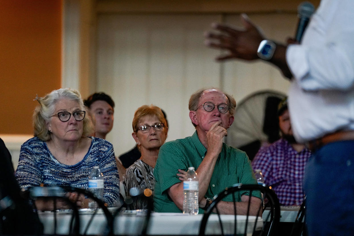 Potential primary voters listen to Scott at a town hall in Concord, N.H.