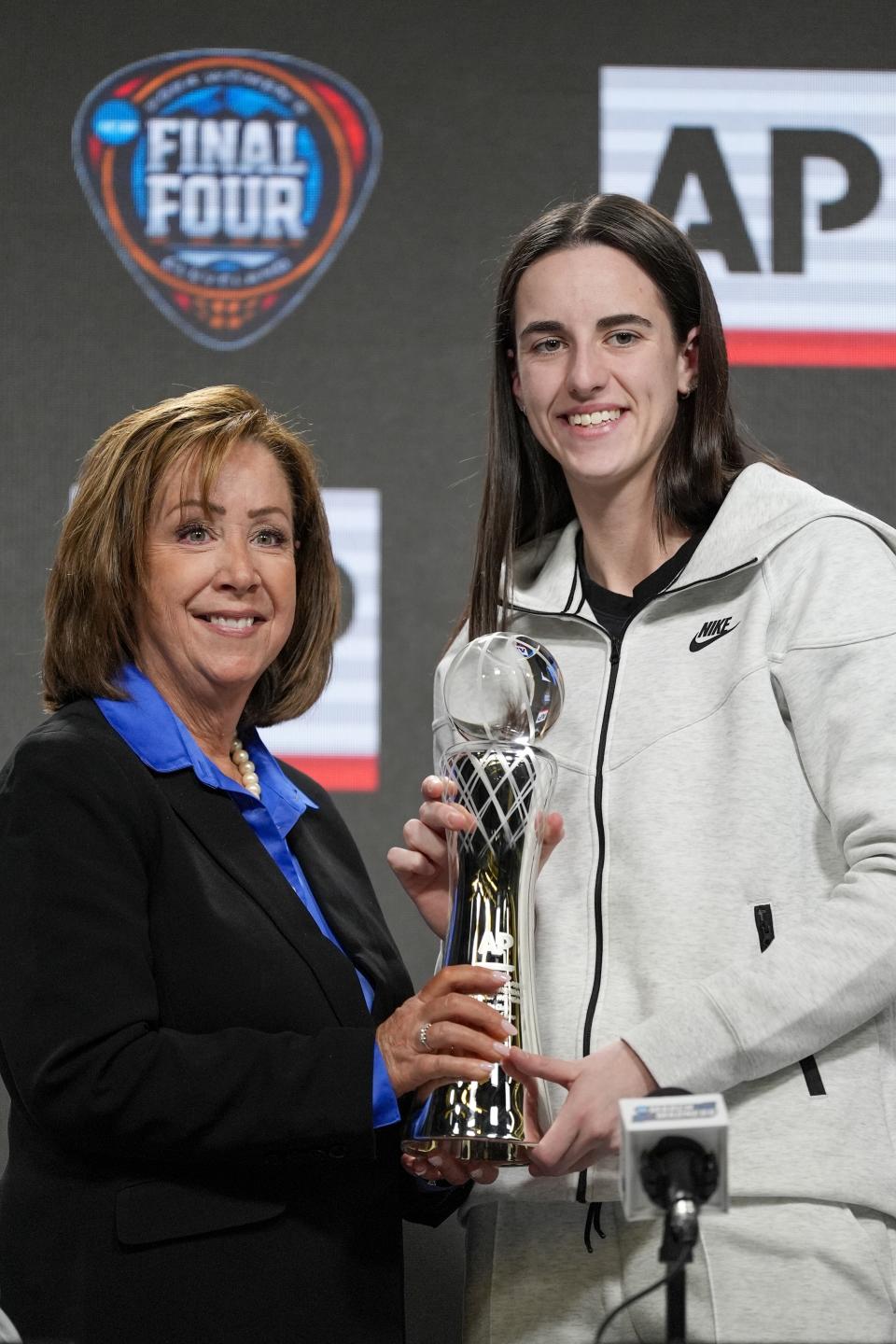 AP's Nancy Nussbaum poses for a photo with Iowa's Caitlin Clark after giving her the AP NCAA Women's Player of the Year award Thursday, April 4, 2024, in Cleveland. (AP Photo/Morry Gash)