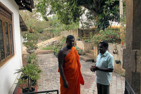 Abdul Saleel Mohamed Fazil and Buddhist monk Gerandigala Chanda Wimala look on at the monk's residence in Digana, Sri Lanka March 16, 2018. REUTERS/Tom Allard