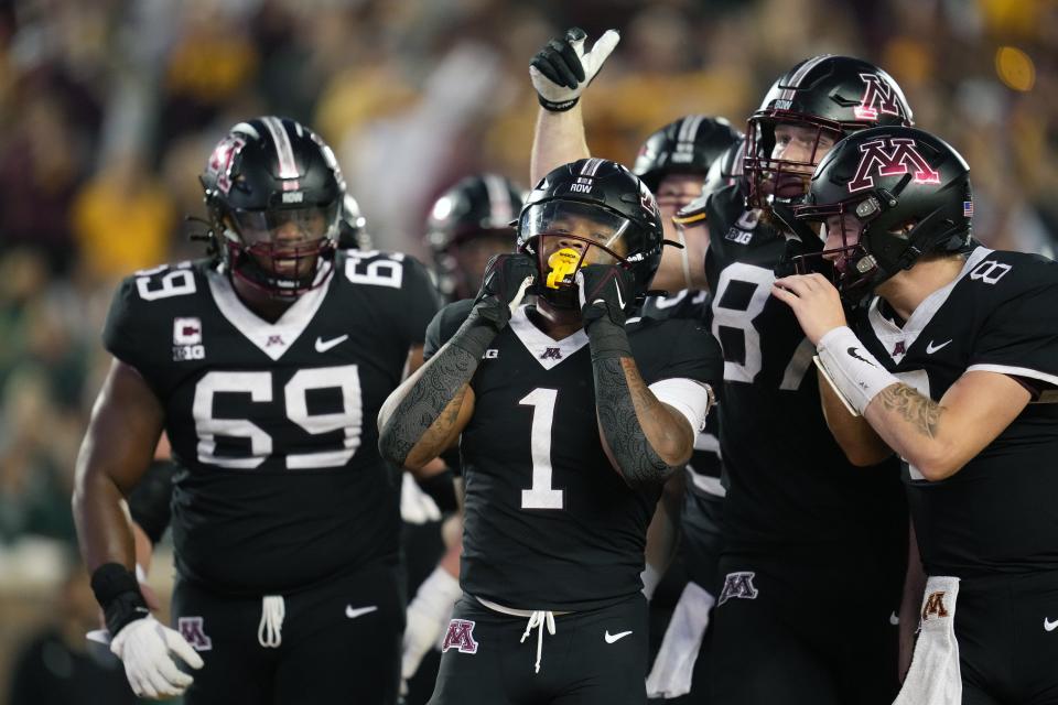 Minnesota running back Darius Taylor (1), center, celebrates after scoring a touchdown during the first half of an NCAA college football game against Eastern Michigan, Saturday, Sept. 9, 2023, in Minneapolis. (AP Photo/Abbie Parr)