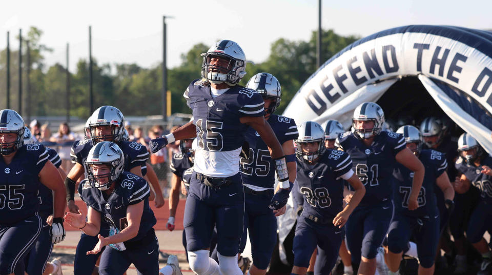 West Clermont wide receiver Chris Henry Jr. (No. 15) and his teammates runs on the field against Hamilton Friday, Aug. 19, 2022.