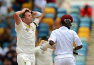 Australian cricketer Peter Siddle (L) reacts as West Indies batsman Kraigg Brathwaite (R) takes a run during the first day of the first-of-three Test matches between Australia and West Indies at the Kensington Oval stadium in Bridgetown on April 7, 2012. West Indies won the toss and elected to bat first. AFP PHOTO/Jewel Samad (Photo credit should read JEWEL SAMAD/AFP/Getty Images)