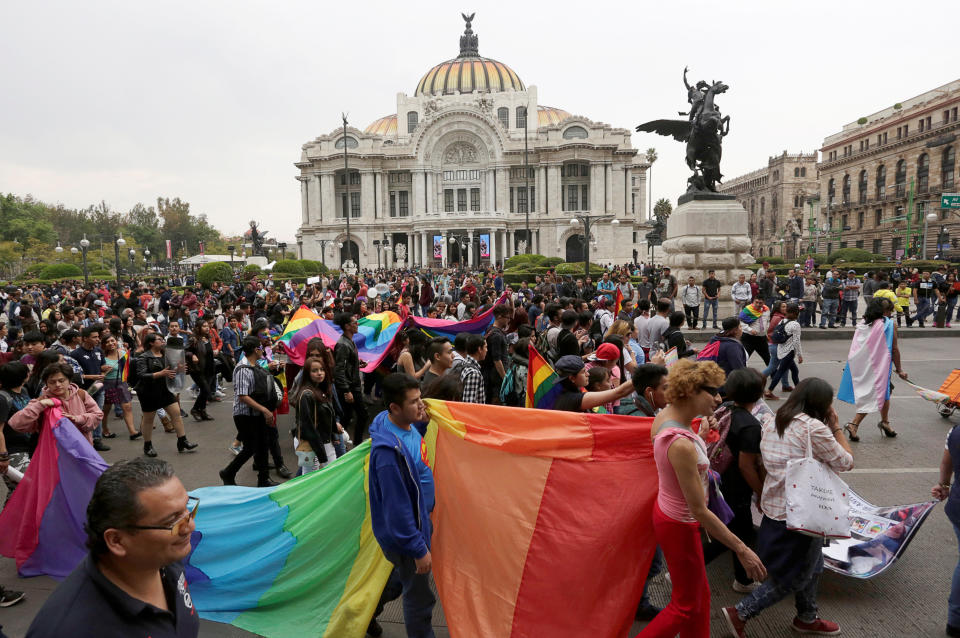 Members of the LGBTQ community carry the rainbow flag during the Lesbian and Gay Pride rally at the Bellas Artes Palace in Mexico City, Mexico on Jan. 27, 2018.