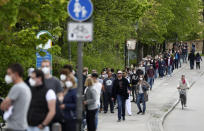 People queue at a vaccination centre in Ebersberg near Munich, Germany, Saturday, May 15, 2021. Hundreds of people have lined up at an improvised vaccination center near Munich to get one of 1,000 doses of the AstraZeneca coronavirus vaccine that were on offer. Police said that around 850 people were standing in line at around 10 a.m. -- and some of them had arrived as early as 5 a.m. (AP Photo/Matthias Schrader)