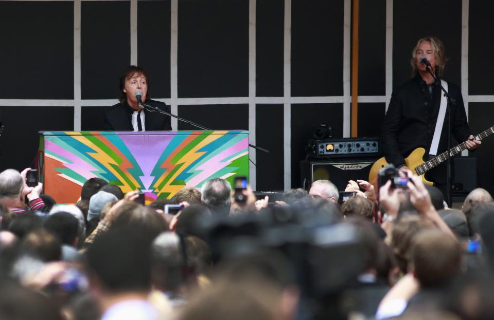 Paul McCartney gestures as he plays surprise mini-concert in New York's Times Square