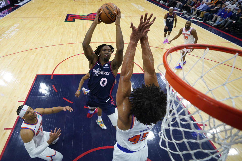 Philadelphia 76ers' Tyrese Maxey (0) goes up for a shot against New York Knicks' Jericho Sims (45) during the first half of an NBA basketball game, Thursday, Feb. 22, 2024, in Philadelphia. (AP Photo/Matt Slocum)