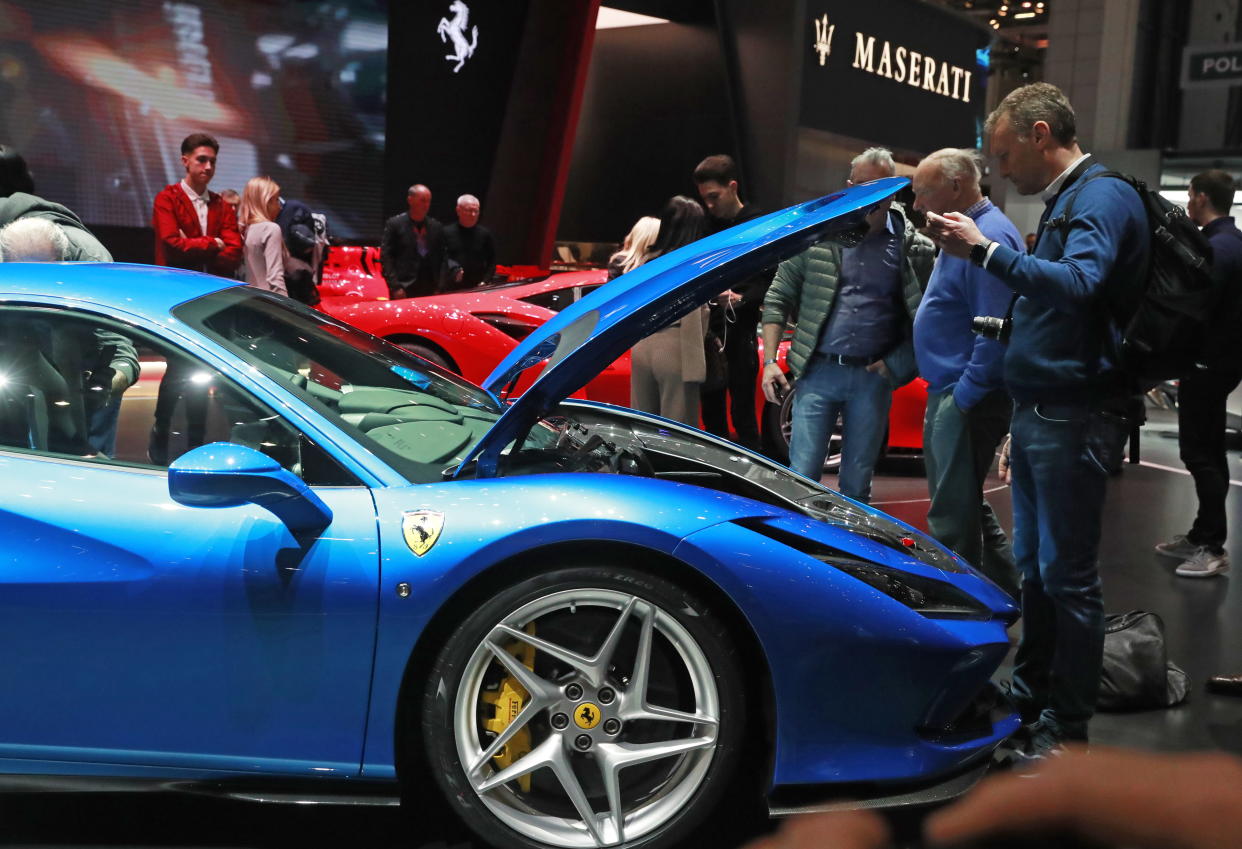 GENEVA, SWITZERLAND - MARCH 7, 2019: People by the Ferrari stand at the 89th Geneva International Motor Show. Sergei Fadeichev/TASS (Photo by Sergei Fadeichev\TASS via Getty Images)