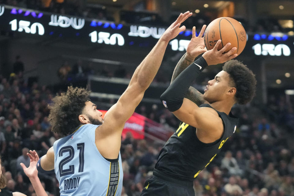Utah Jazz guard Keyonte George, right, shoots as Memphis Grizzlies David Roddy (21) defends during the first half of an NBA basketball game Wednesday, Nov. 1, 2023, in Salt Lake City. (AP Photo/Rick Bowmer)