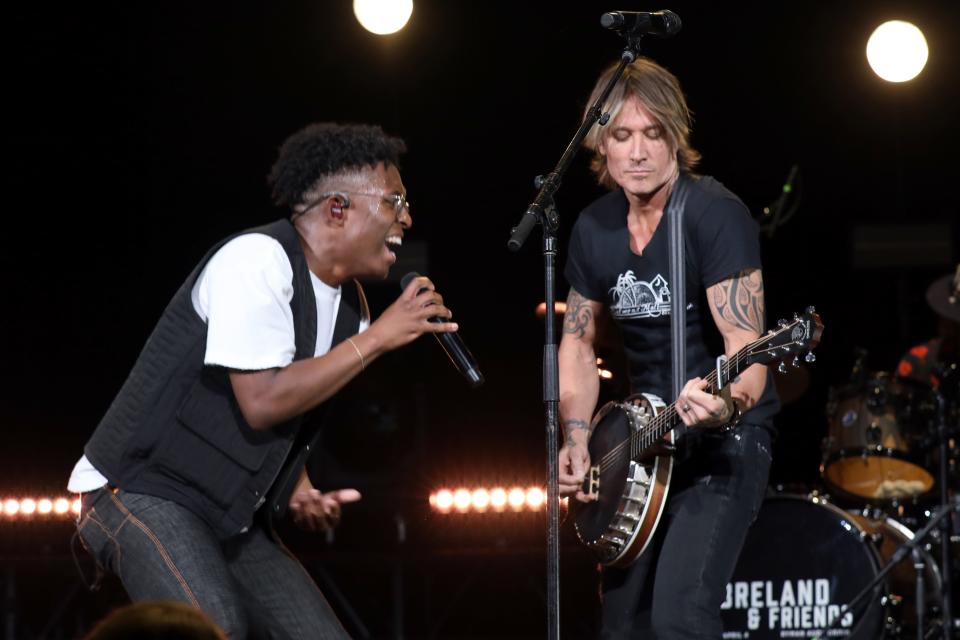 BRELAND and Keith Urban perform onstage for "BRELAND & Friends" benefit for Oasis Center presented by Amazon Music at Ryman Auditorium on April 04, 2023 in Nashville, Tennessee.