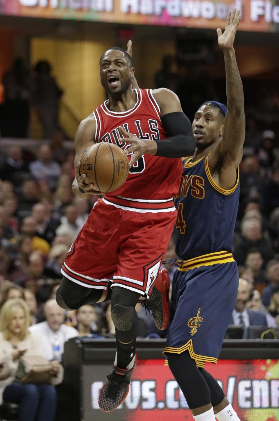 Chicago Bulls' Dwyane Wade (3) is fouled by Cleveland Cavaliers' Iman Shumpert (4) in the first half of an NBA basketball game, Saturday, Feb. 25, 2017, in Cleveland. (AP Photo/Tony Dejak)