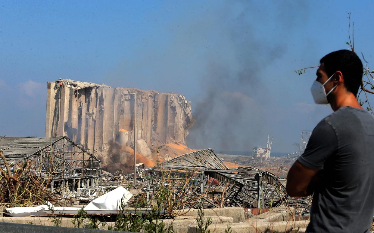 A man surveys the aftermath of the powerful twin explosion that tore through Lebanon's capital - AFP