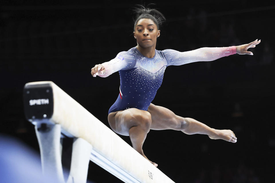 Simone Biles balances on a beam during the Artistic Gymnastics World Championships (Geert vanden Wijngaert / AP)