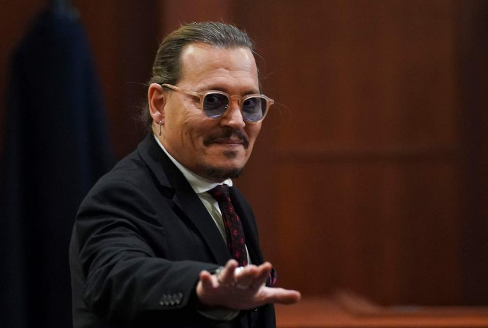 Johnny Depp waves as he leaves the courtroom in Fairfax on Wednesday (POOL/AFP via Getty Images)