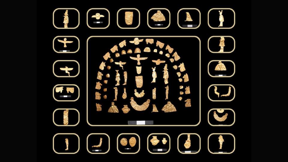  A compilation of small, gold-toned artifacts including coins and figurines of gods. 