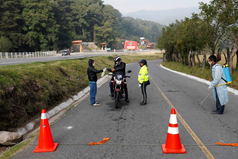 Community members operate a checkpoint at the entrance to the village of Tecpan amid the outbreak of the coronavirus disease (COVID-19), in Chimaltenango