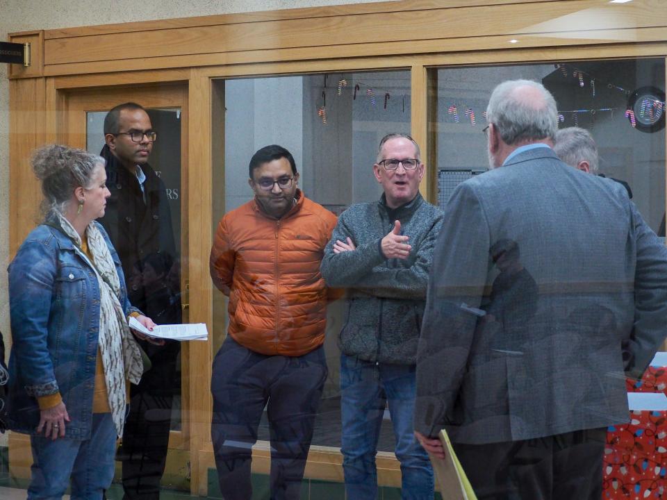 Residents speak to Mark DeYoung, the Tippecanoe School Corporation's attorney after the December's Tippecanoe County's Area Plan Commission meeting regarding the TSC's decision to rezone a plot of land, on Wednesday, Dec. 21, 2023, in Lafayette, Ind.